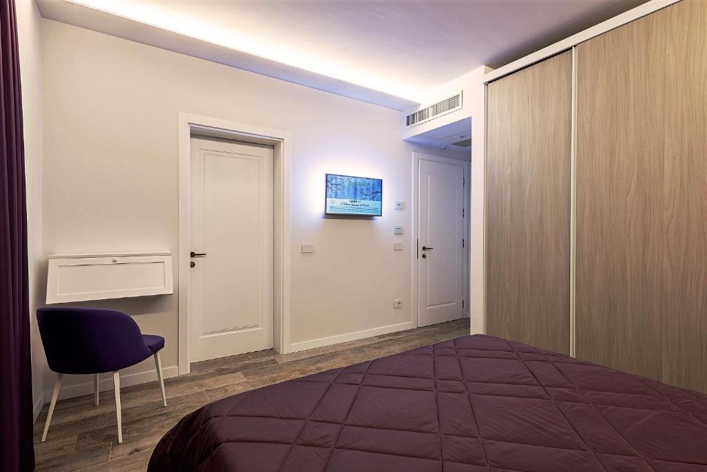 Postel nebo postele na pokoji v ubytování Petit Hotel