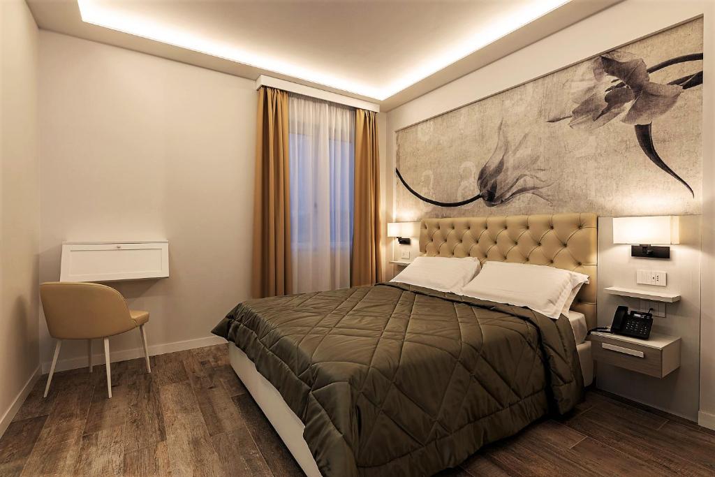 Postel nebo postele na pokoji v ubytování Petit Hotel