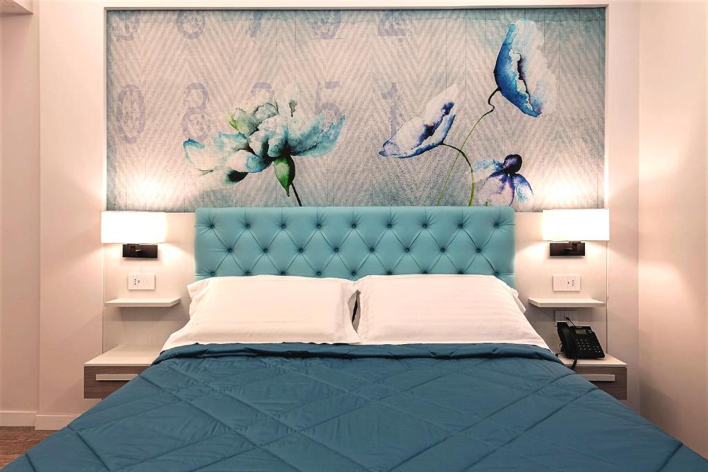 Postel nebo postele na pokoji v ubytování Petit Hotel