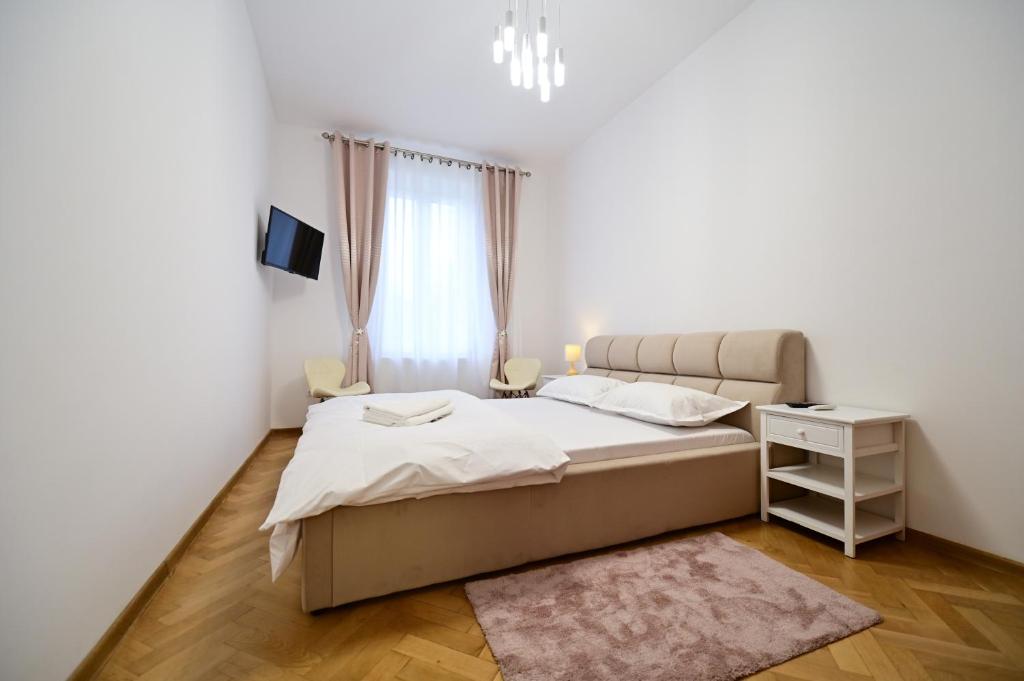 a bedroom with a bed and a window at FLH - Kaly's Place in Sibiu