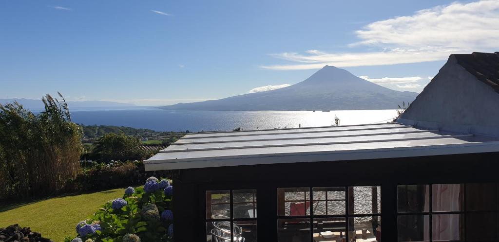 a house with a view of a mountain and water at Casa Vista Fantástica in Pedro Miguel