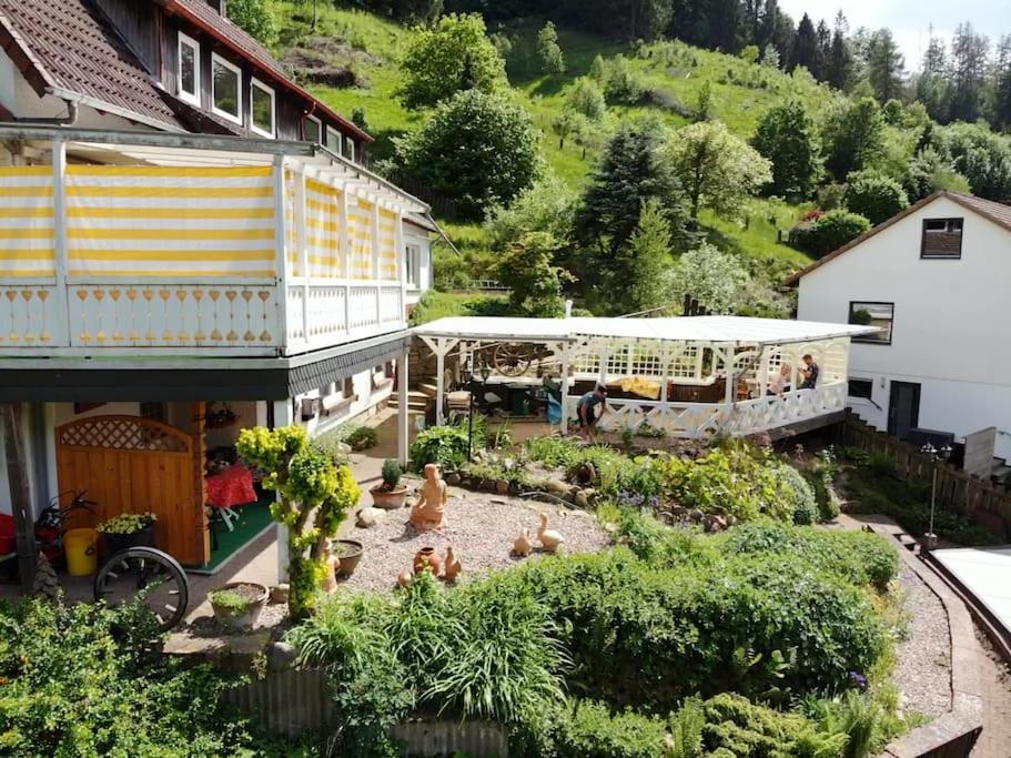 a garden in front of a building with a train at Ferienwohnung am Hang mit malerischer Aussicht in Osterode