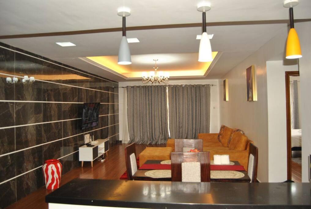 a living room with a couch and a table at Complete specious and central apartment in n Nairobi - Kilimani in Nairobi