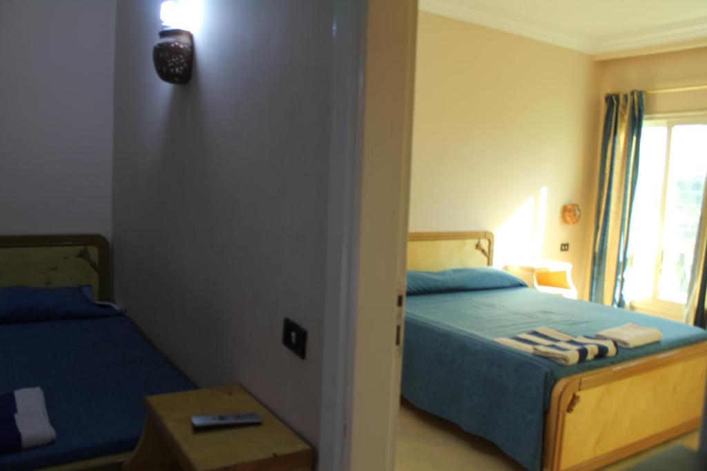 Postel nebo postele na pokoji v ubytování Golden Rose Hotel