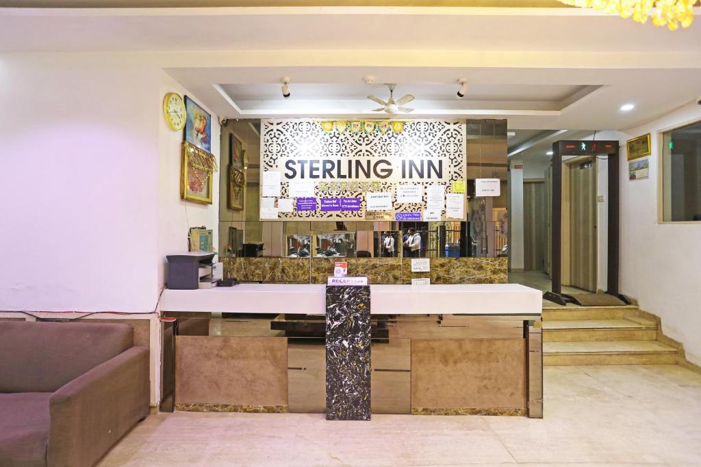 a lobby of a waiting room with a table and chairs at Hotel Sterling Inn, New Delhi in New Delhi