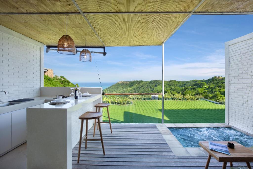 an open kitchen with a view of the ocean at Telescope Resort Lombok in Kuta Lombok