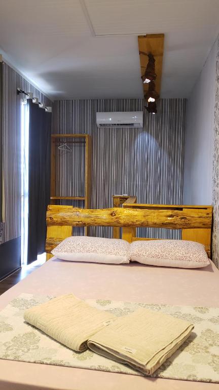 a bedroom with a large bed with a wooden headboard at Apart-Container Penha in Navegantes