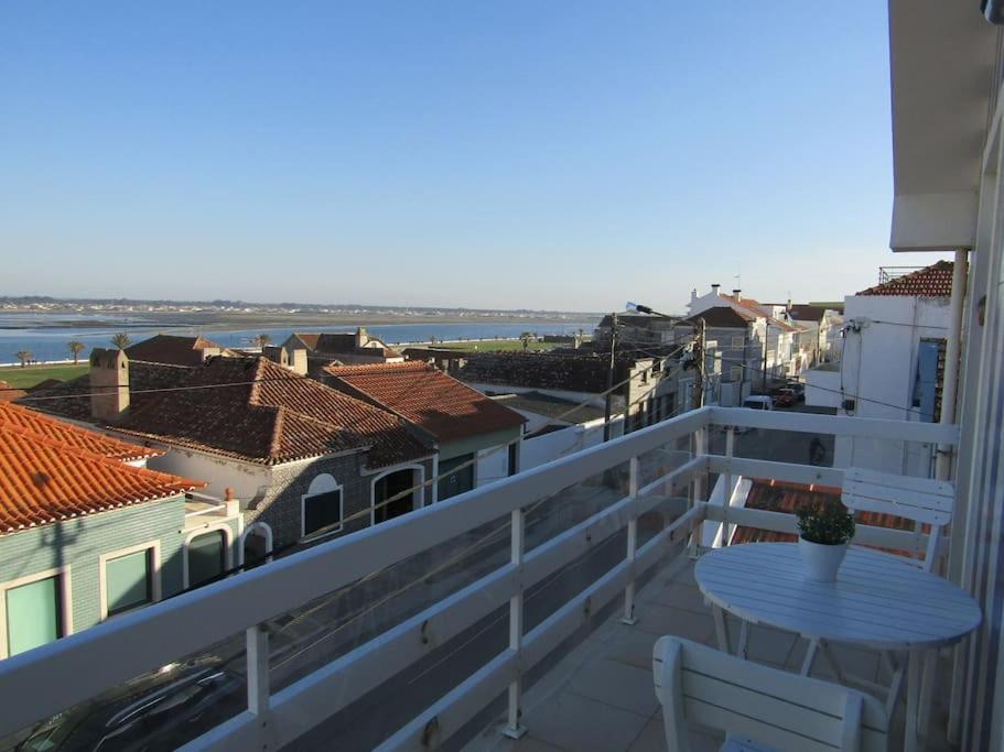 een balkon met een tafel en uitzicht op de oceaan bij Apartamento Panorâmico das Dunas da Bela Vista in Gafanha da Encarnação