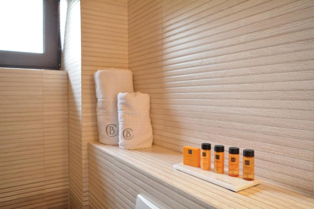 a sauna with three bottles of soap on a shelf at Pensiunea Charlotte Boutique in Bacău