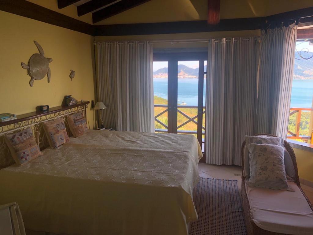 Cama o camas de una habitación en Vila de duas casas em Ilhabela com 9 suites