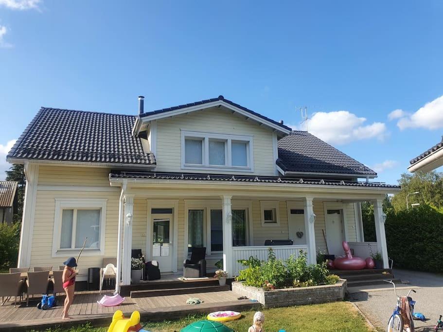 a house with children playing in the yard at Modern 6-bedroom villa near Tampere city in Tampere