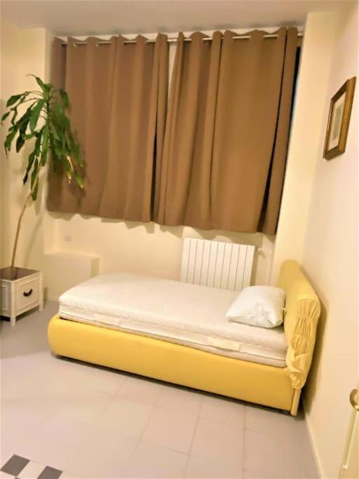 A bed or beds in a room at Affori Residence