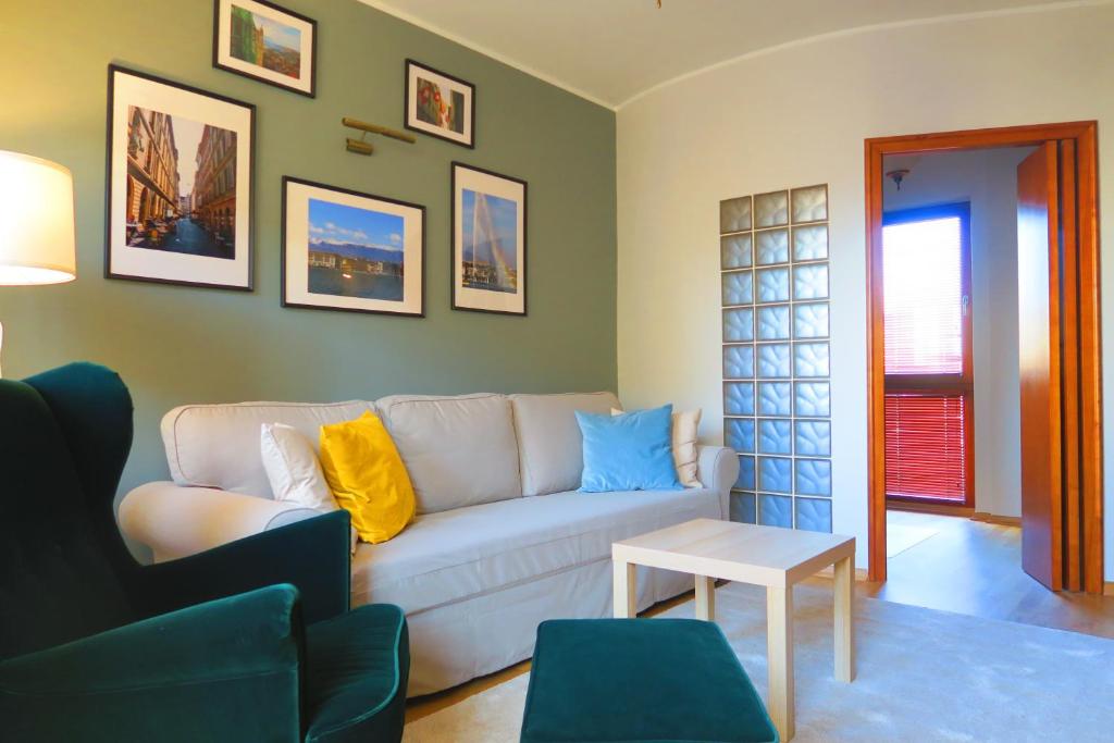 a living room with a white couch and a table at Apartament Geneva in Warsaw