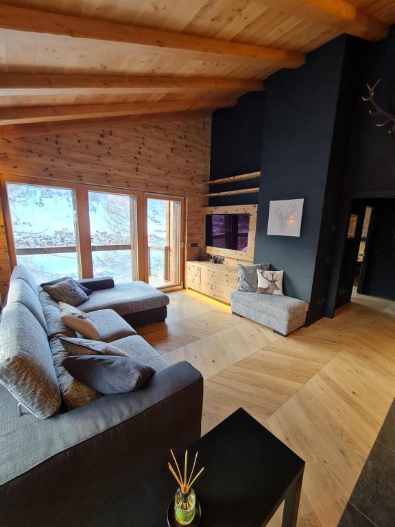a living room with a couch and a tv at Blackberry Apartment in Livigno