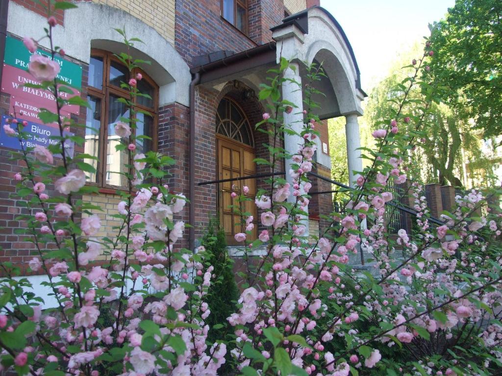 a house with pink flowers in front of it at Pokoje Gościnne Centrum Kultury Prawosławnej in Białystok