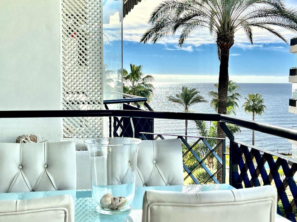 a table with chairs and a view of the ocean at MI CAPRICHO 3-5 BEACHFRONT- Apartment with sea views in Costa del Sol in Mijas Costa
