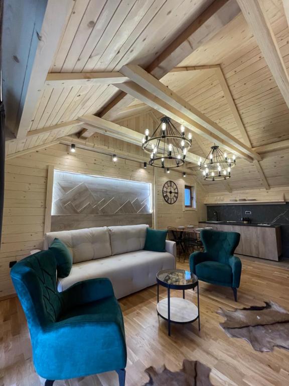 ein Wohnzimmer mit einem Sofa, 2 Stühlen und einem Tisch in der Unterkunft Chalet Montenegrina with jacuzzi in Kolašin