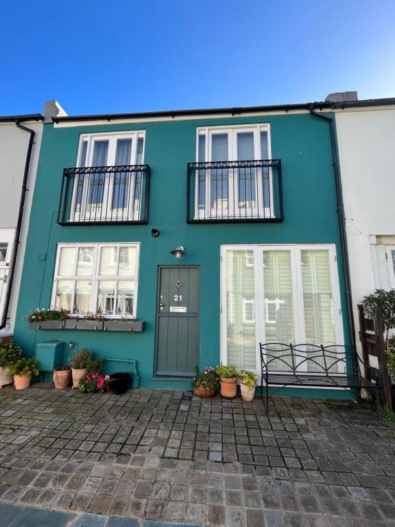 a blue house with white windows and a door at Charming BRIGHTONMEWS cottage parking 1min to sea&shops in Brighton & Hove