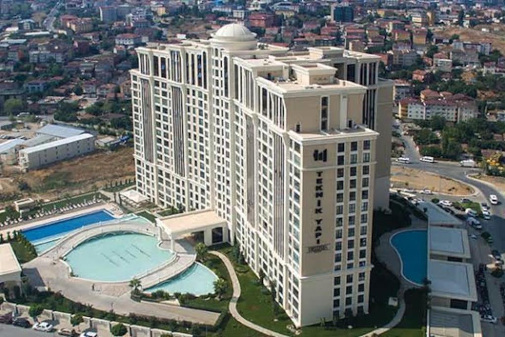 an aerial view of a large white building with a pool at Ataşehir Lüks Rezidans in Istanbul