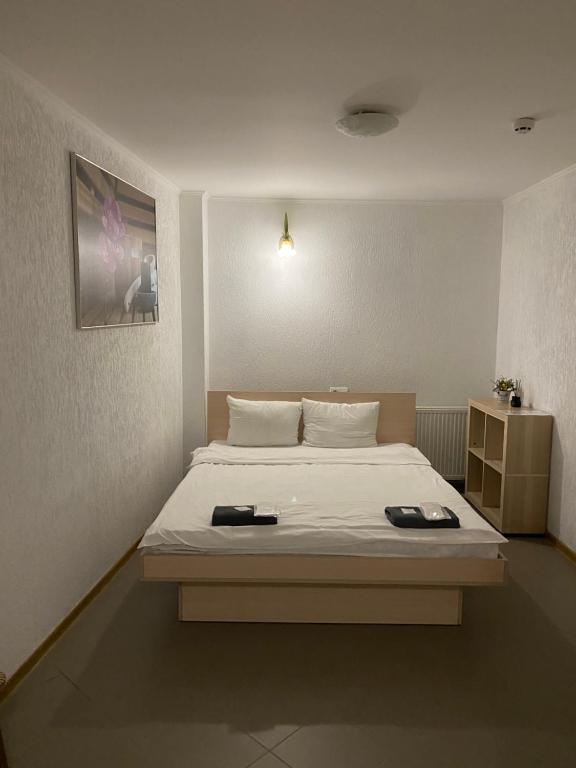 a bedroom with a bed with two plates on it at Відпочинковий комплекс,міні готель Старий дворик in Lviv