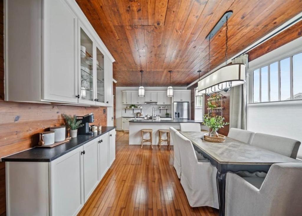 a kitchen with white cabinets and a wooden ceiling at Coastal Craftsman- Walk to Beach & Pleasure Pier- As seen on 'Restoring Galveston' in Galveston