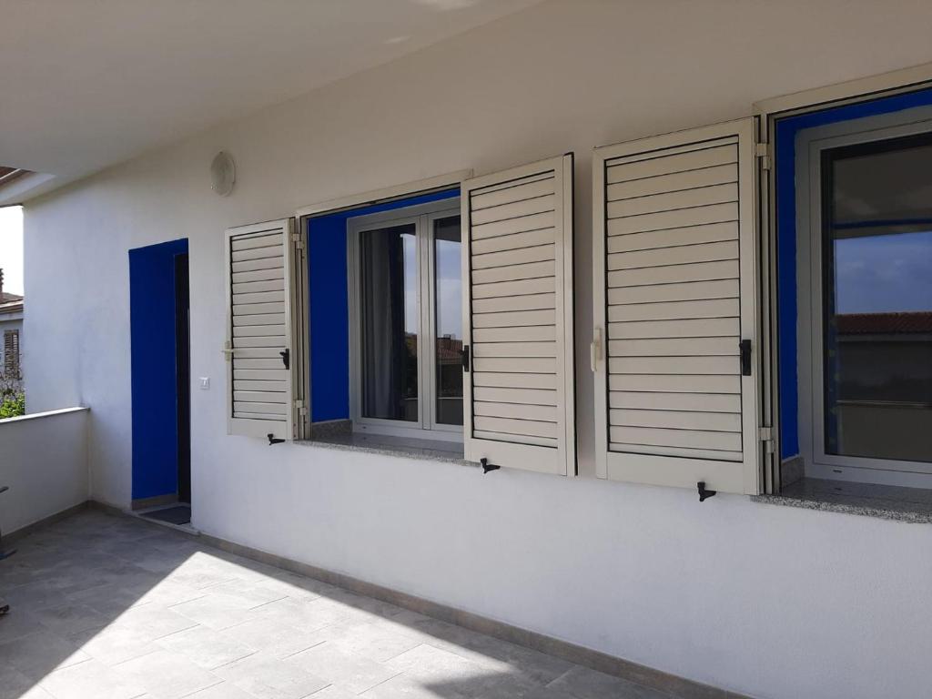 a row of windows on a white building at ARC BLEu in Siniscola