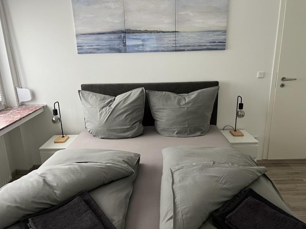 a bed with two pillows on it in a bedroom at Eine Wohnung zum wohlfühlen in Lübbecke