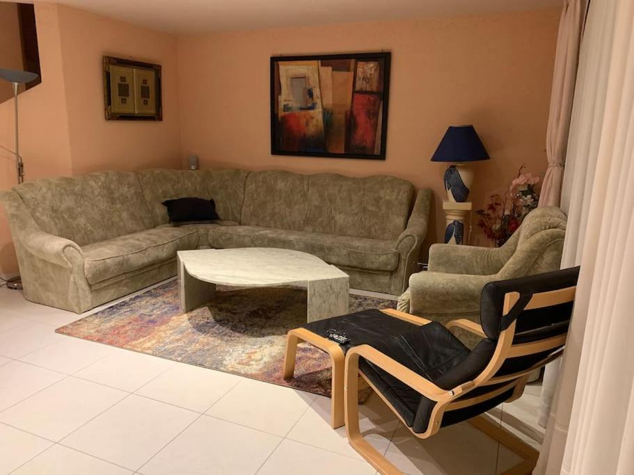 a living room with a couch and a table at Beautiful house with free parking on premise in Utzenstorf