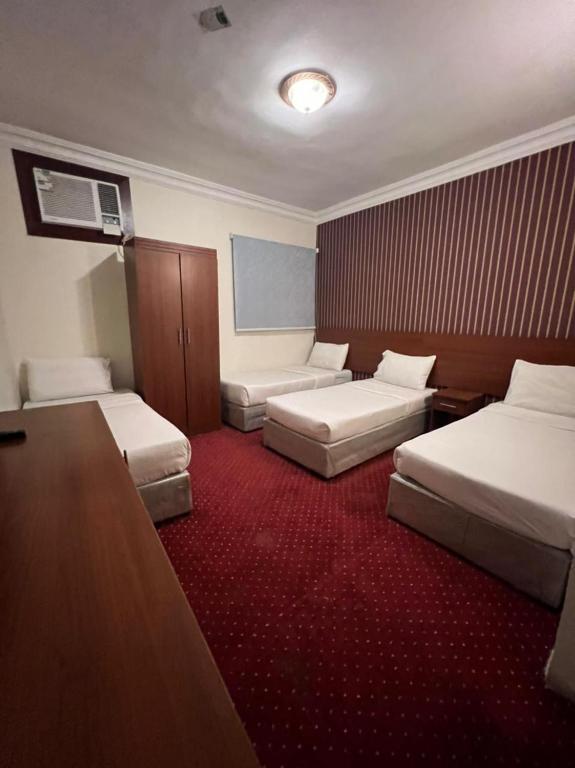 Postel nebo postele na pokoji v ubytování فندق كنان العزيزية Kinan Al Azizia Hotel Makkah