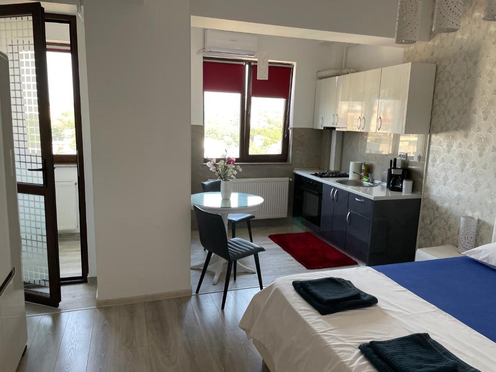 a small kitchen with a table and a dining room at No. 110 / Downtown in Iaşi