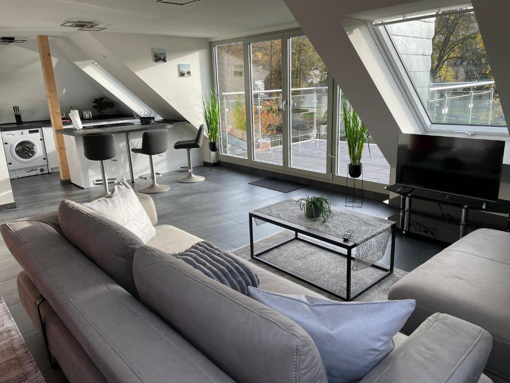a living room with a couch and a table at Exklusive Wohnung mit Ahrblick 1 und Dachterrasse in Bad Neuenahr-Ahrweiler