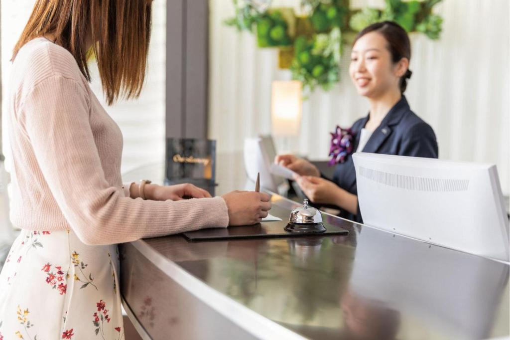 two women sitting at a desk with a laptop at Hotel JAL City Haneda Tokyo in Tokyo