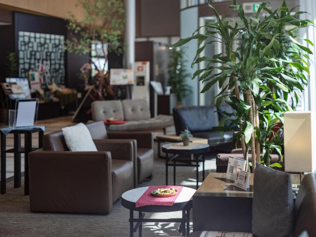 a living room with couches and tables and plants at Hotel JAL City Haneda Tokyo in Tokyo