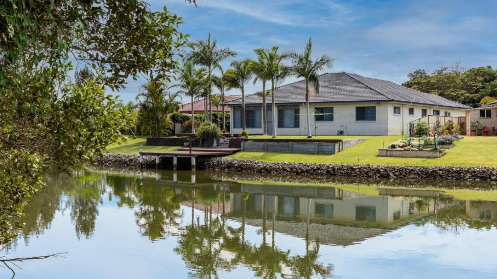 a house with a river in front of it at Newport Retreat in Yamba