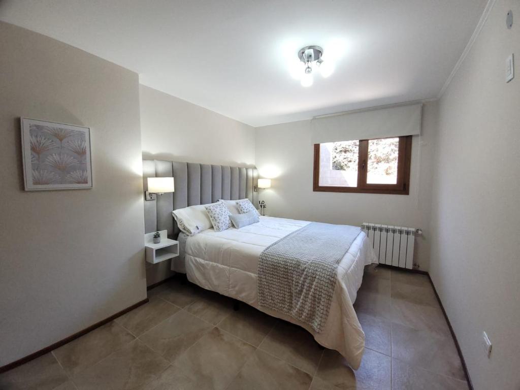 Un pat sau paturi într-o cameră la Aires del Sur