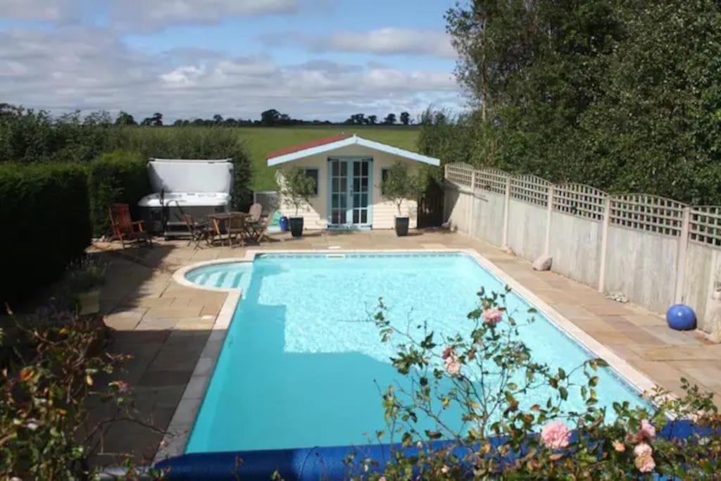 a swimming pool in the backyard of a house at The Owl House with private hot tub in Newport