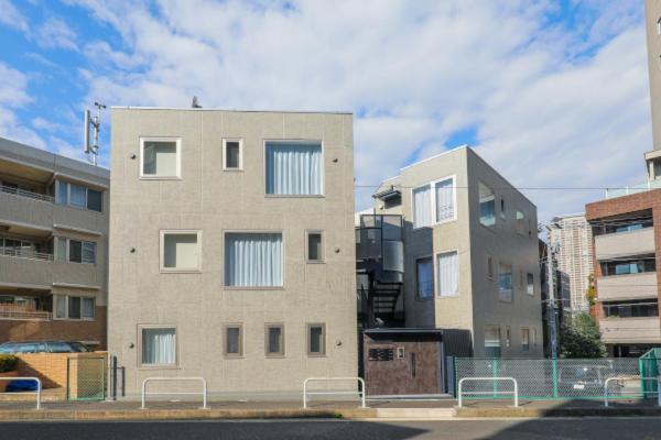 a tall building with a fence in front of it at Space Roppongi in Tokyo