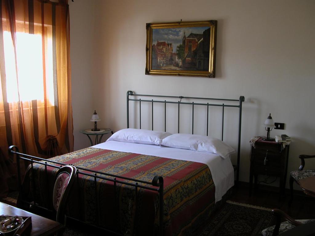 Postel nebo postele na pokoji v ubytování Hotel Canusium