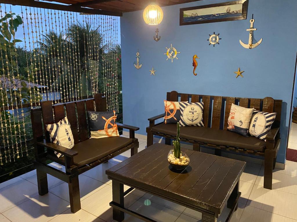 a room with two chairs and a table and a window at Pousada Casa Berna in Fernando de Noronha