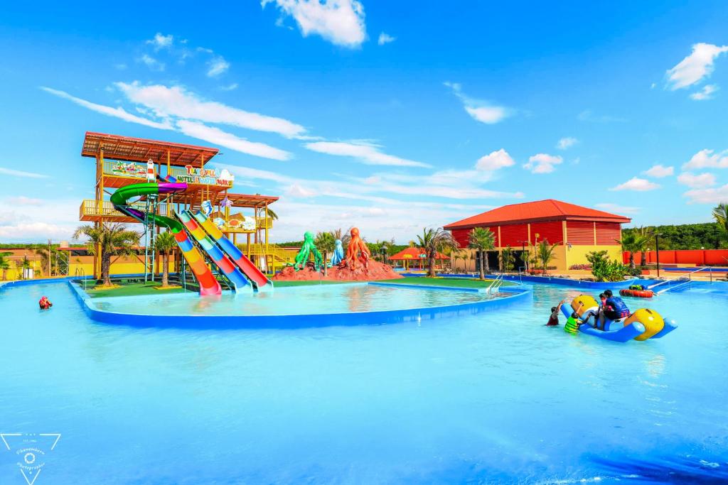 a water park with a water slide and people on tubes at Trang Villa Hotel and Water Park in Trang