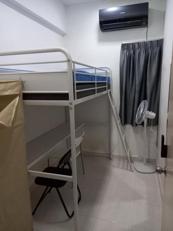 a dorm room with a bunk bed and a fan at HOT!!!Tropics Homestay Private Male Dorm Damansara in Petaling Jaya