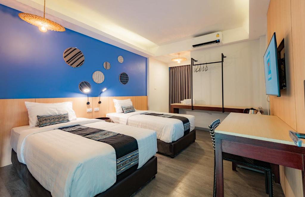 Ένα ή περισσότερα κρεβάτια σε δωμάτιο στο Luck Thai Hotel