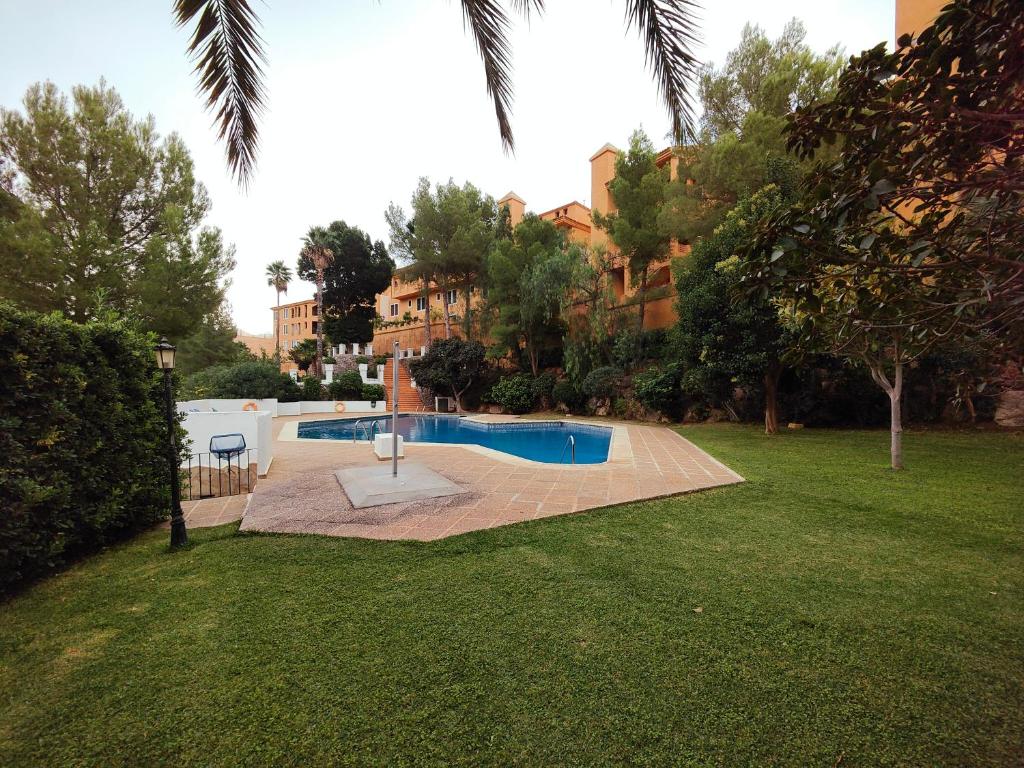 a swimming pool in the middle of a yard at Luxury Apartments Mascarat in Altea