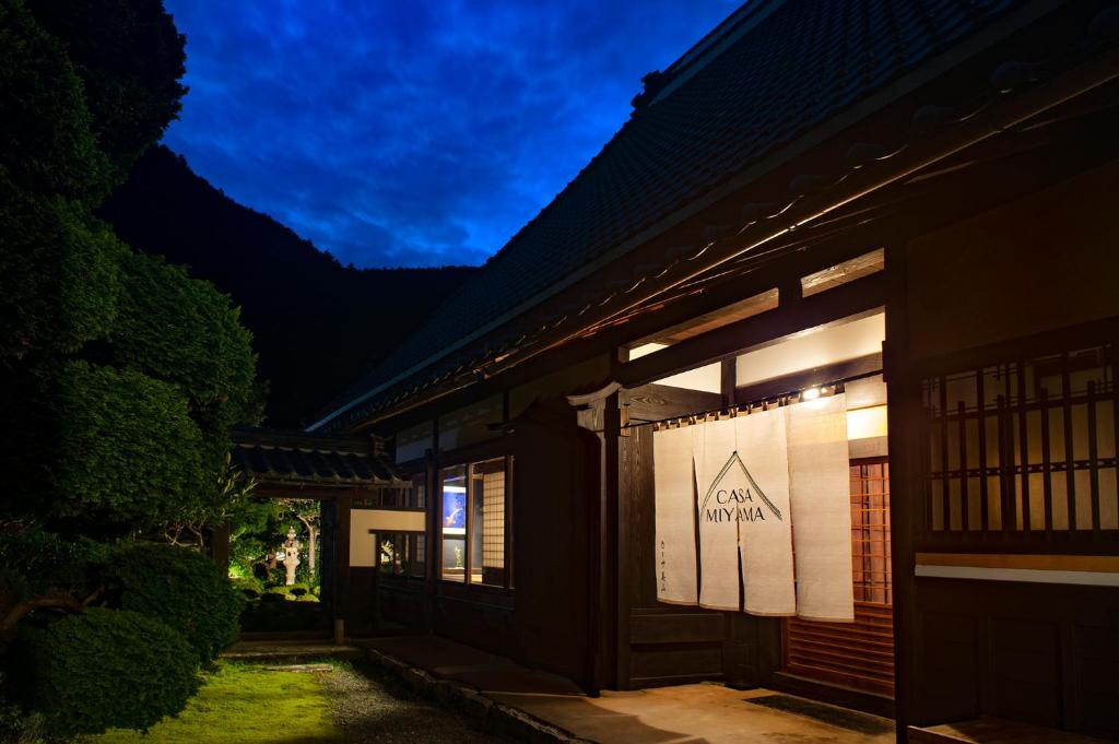 a building with a sign on the side of it at Casa Miyama in Nantan city