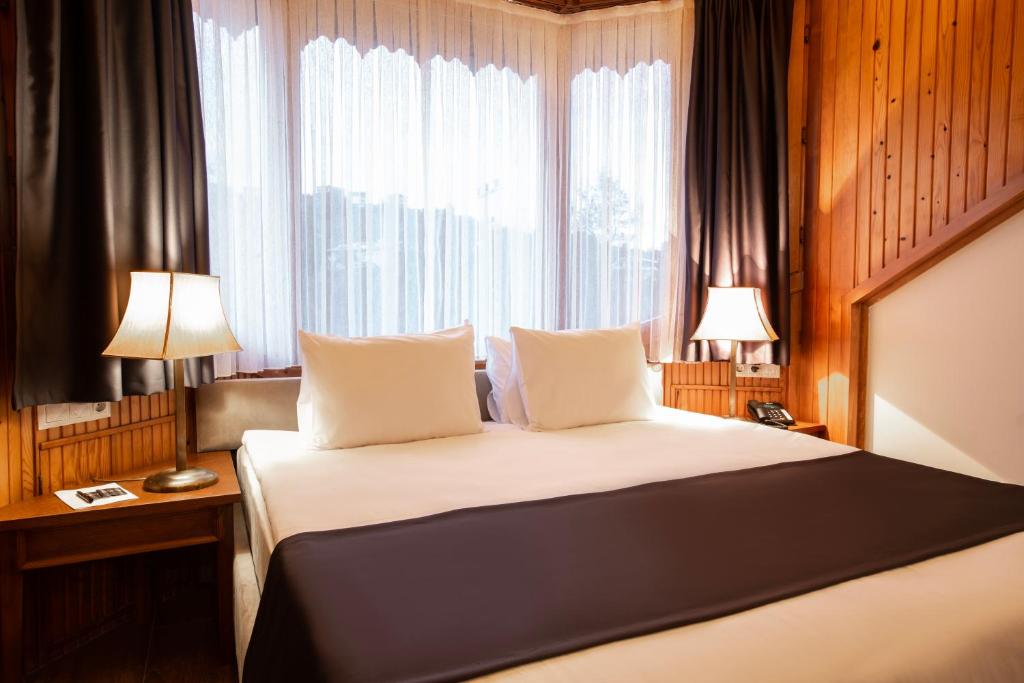 Postel nebo postele na pokoji v ubytování Zanike hotel