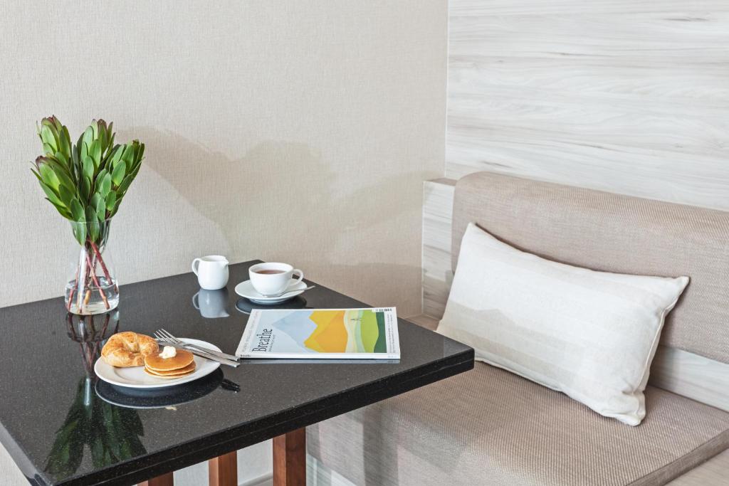 A small in-room dining or work table set beside an upholstered bench.