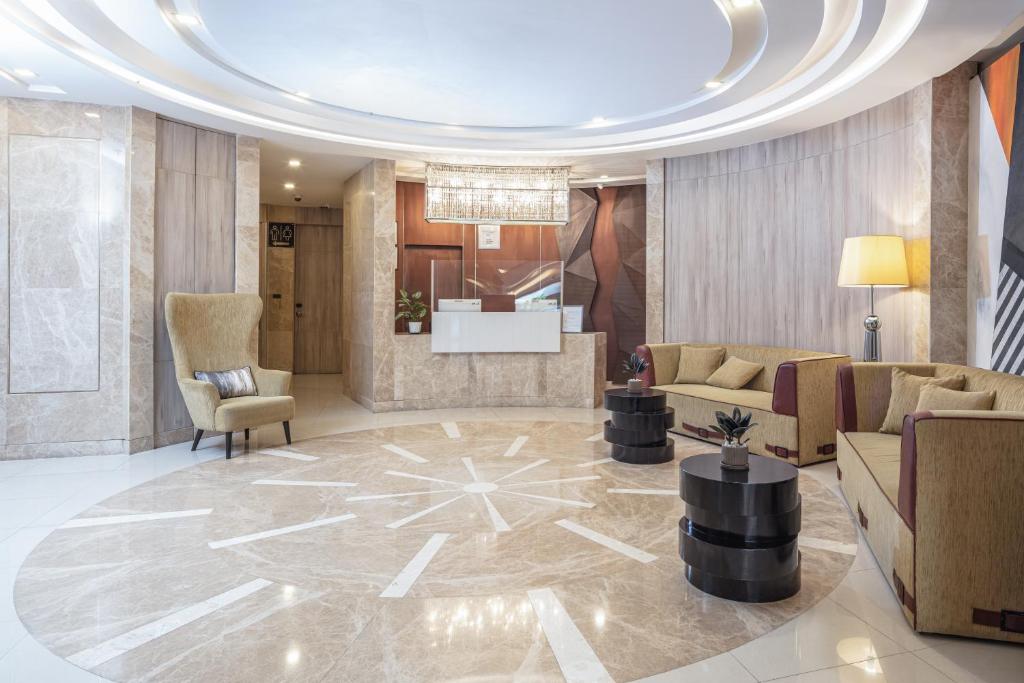 A spacious reception lobby with a curved seating zone and visible elevator or corridor access.