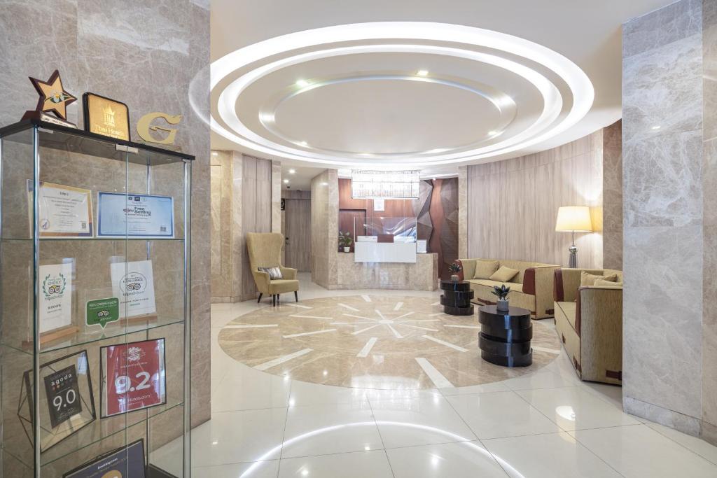 A hotel entrance lobby framed by a circular illuminated ceiling and award display.