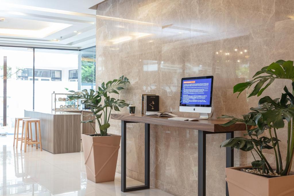 A compact public workstation beside a bright windowed seating area.