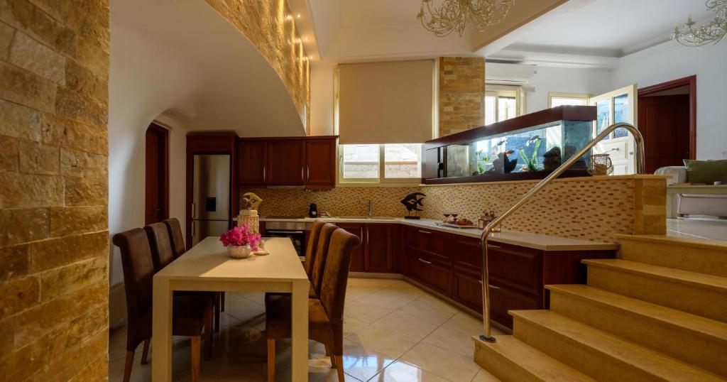 a kitchen with a table and a dining room at Suite Home Santorini in Fira
